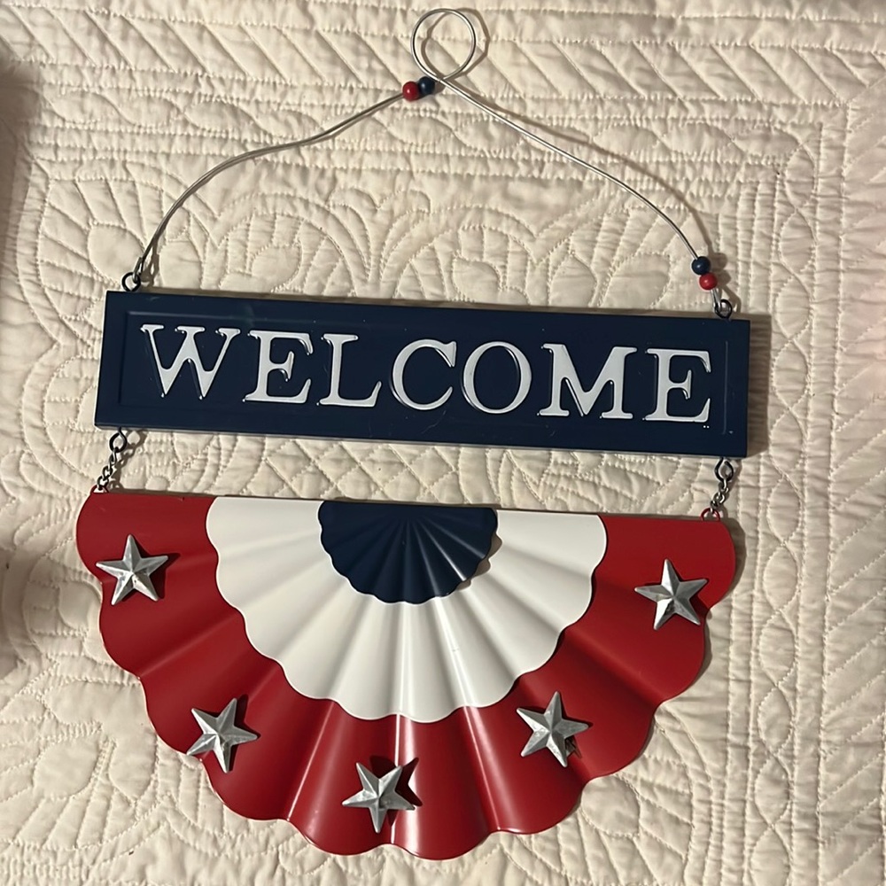 Metal welcome sign with American flag